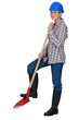 Woman construction worker with a shovel