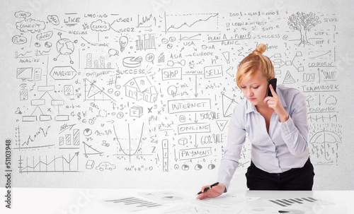 Photo: Pretty businesswoman planning and calculating various business i Pretty businesswoman planning and calculating various business i