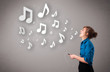 Pretty young woman singing and listening to music with musical n