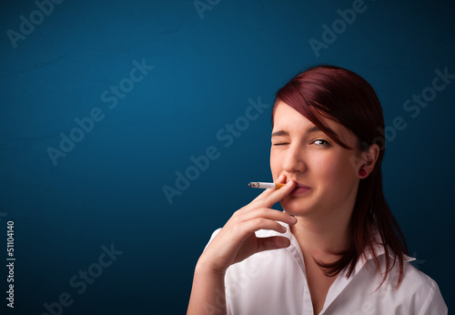 Photo: Beautiful woman smoking cigarette vith copy space Beautiful woman smoking cigarette vith copy space