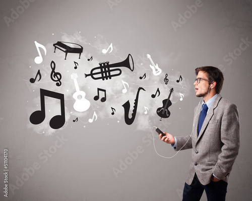 Photo: attractive young man singing and listening to music with musical attractive young man singing and listening to music with musical