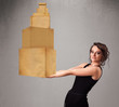 Young lady holding a set of brown cardboard boxes