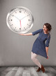 Attractive lady holding a huge clock