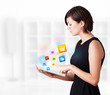 Young woman looking at modern tablet with colourful icons