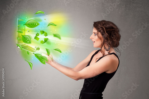 Photo: Casual woman holding notebook with recycle and environmental sym Casual woman holding notebook with recycle and environmental sym