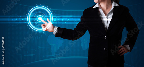 Photo: Woman pressing high tech type of modern buttons Woman pressing high tech type of modern buttons