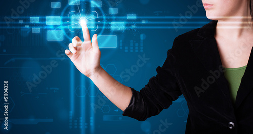 Photo: Woman pressing high tech type of modern buttons Woman pressing high tech type of modern buttons