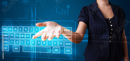 Photo: Girl pressing virtual type of keyboard Girl pressing virtual type of keyboard