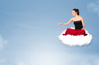 Young woman sitting on cloud with copy space