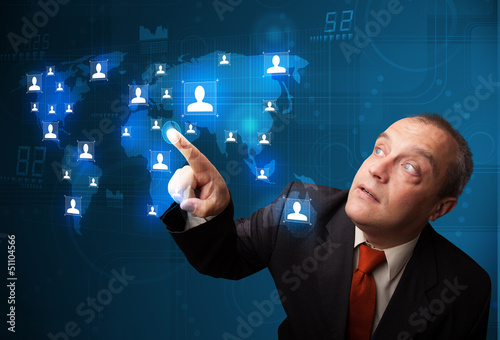 Photo: Businessman choosing from social network map Businessman choosing from social network map
