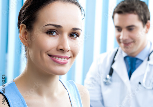 Photo: Portrait of smiling doctor and female patient Portrait of smiling doctor and female patient