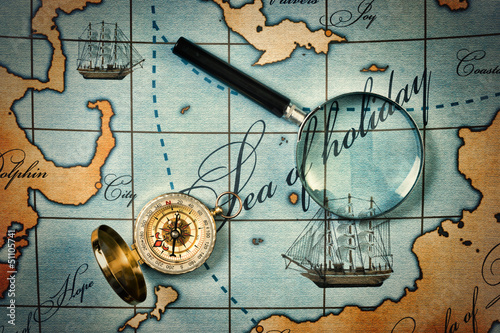 Photo: magnifier and compass on map magnifier and compass on map