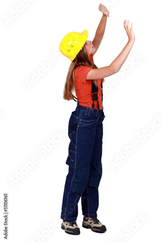 Photo: A female construction worker checking the walls. A female construction worker checking the walls.