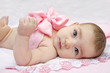 Baby with a bow on pink background