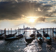 Venice with gondolas against sunset in Italy