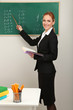 Portrait of teacher woman near chalkboard in classroom