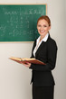 Portrait of teacher woman near the chalkboard in classroom