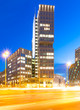 Modern Business Building with Lights and Traffic
