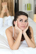 pensive woman on bed