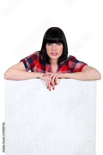 Photo: brunette with helmet haircut leaning on board brunette with helmet haircut leaning on board