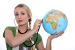 HOLDING, STETHOSCOPE  ON GLOBE