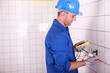 Electrician testing the current with a multimeter