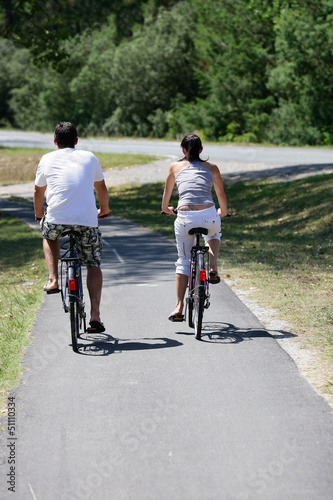 Photo: Man and woman having a bike ride Man and woman having a bike ride