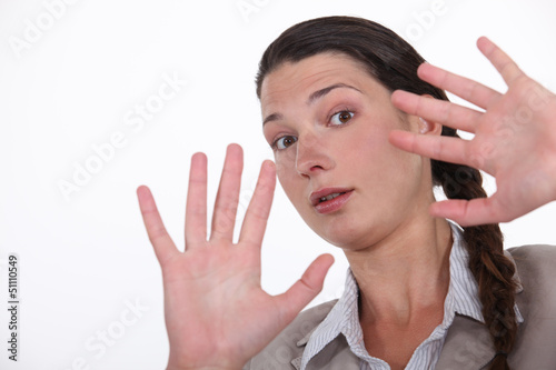 Photo: Shocked woman holding hands up Shocked woman holding hands up