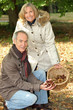 Photo: Middle-aged couple gathering chestnuts Middle-aged couple gathering chestnuts