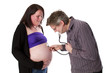 Father-to-be is auscultating mums belly.
