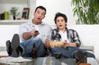 Father and son watching television