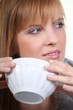 Foto: Woman enjoying a hot drink Woman enjoying a hot drink