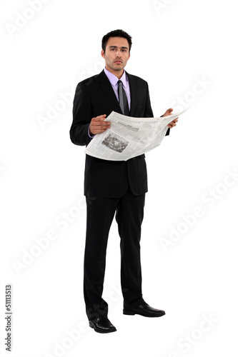 Photo: Businessman reading a newspaper Businessman reading a newspaper