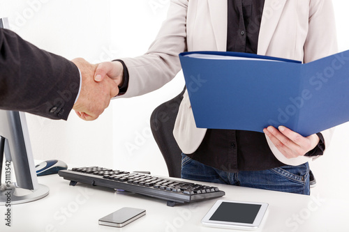 Photo: Businesswoman with briefcase man shakes the hand Businesswoman with briefcase man shakes the hand
