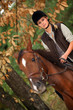 Blond woman riding horse