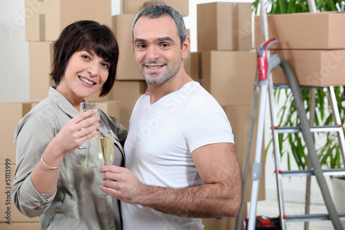 Photo: Happy couple moving into new apartment Happy couple moving into new apartment