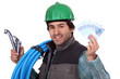 Plumber holding a tap and his hard-earned salary