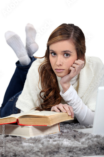 Photo: Woman reading book on the floor Woman reading book on the floor
