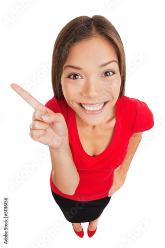 Photo: Grinning woman pointing to left of frame Grinning woman pointing to left of frame