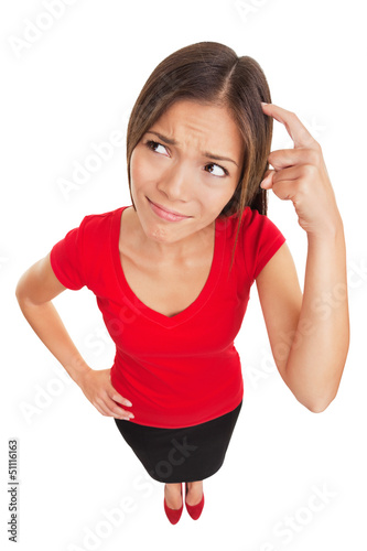 Photo: Confused woman scratching her head Confused woman scratching her head