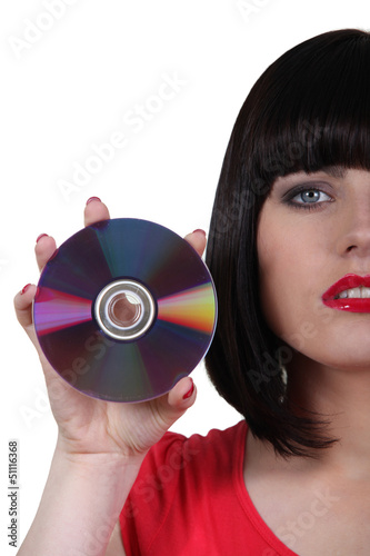 Photo: Young woman showing compact disc Young woman showing compact disc