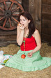 Young girl has lunch on a hayloft
