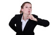 secretary with finger before her mouth
