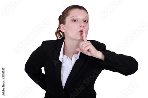 Photo: secretary with finger before her mouth secretary with finger before her mouth