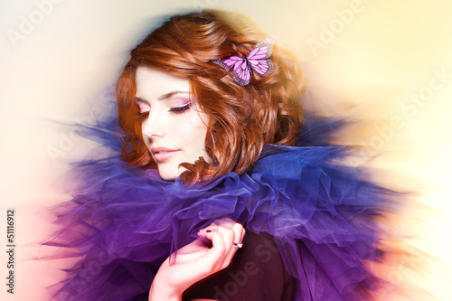 Photo: pretty woman with a butterfly in her hair - beauty shot pretty woman with a butterfly in her hair - beauty shot
