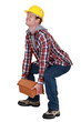 Tradesman lifting a heavy load