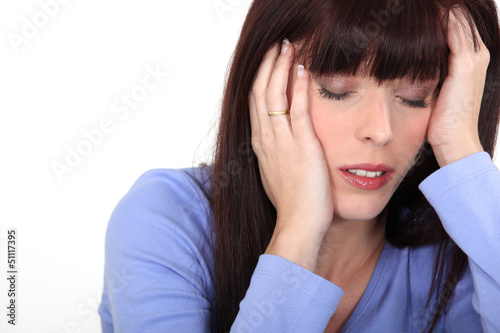 Photo: young woman having migraine young woman having migraine