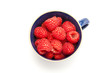 Cup of raspberries on white background