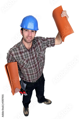 Photo: Man holding roof tiles Man holding roof tiles
