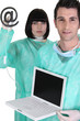 Doctors treating a computer for a virus